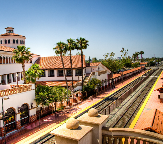 Train station in Santa Ana California, surrounded by greenery and under a clear blue sky.